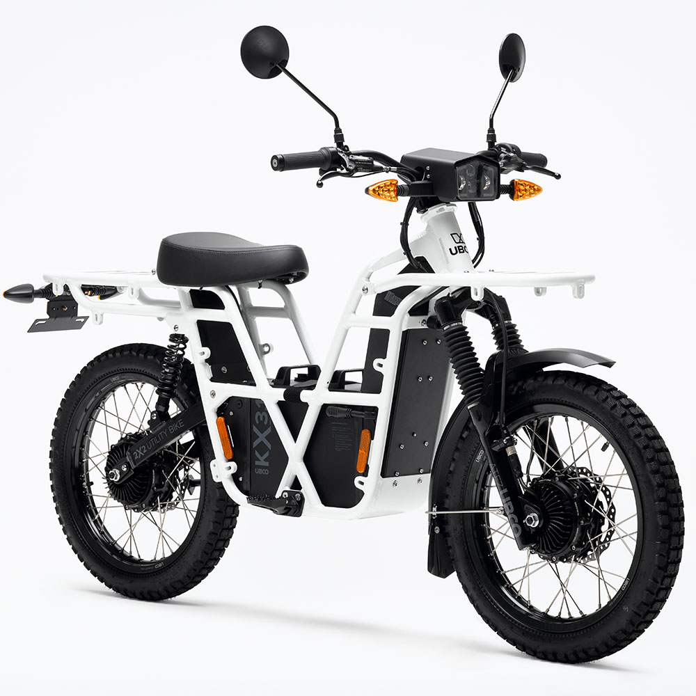 UBCO 2X2 Adventure Bike - White On-road or off-road, this electric motorbike is conveniently lightweight, making it easy to lift onto your van, truck or RV. Humming under 75dB with a range up to 120km, you can discover new far off places while enjoying the sound of nature. With a total carry weight of 150kg you can take the bigger tent and the extra pots without all the fuss. Top speed 45km/h | 28mph Weight incl. power supply 66-71kg | 145-156lb Max range 70-120km | 43-75mi